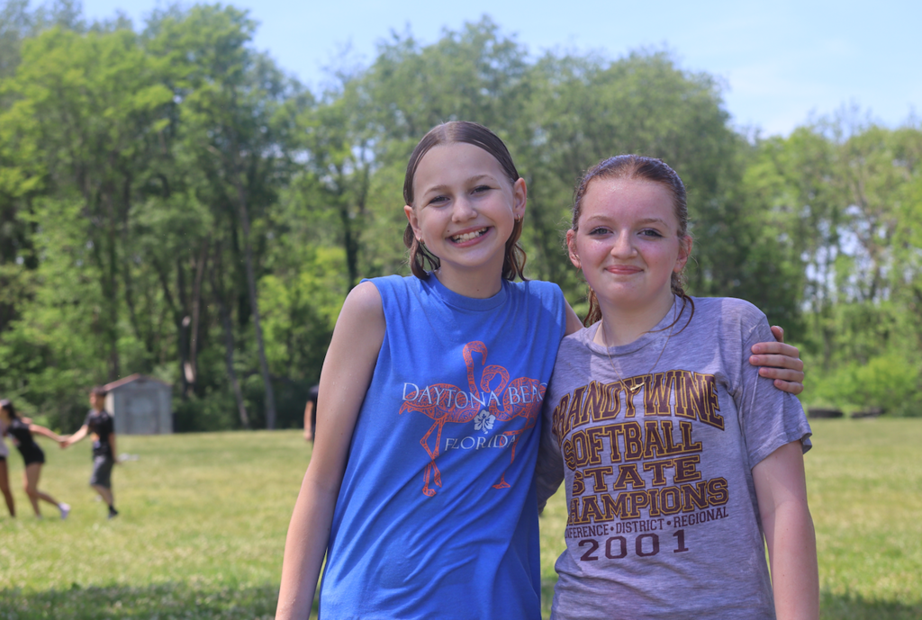 two girls smiling at camera