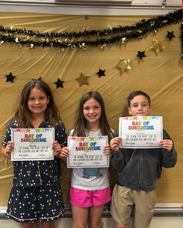 three girls  holding certificates for awards