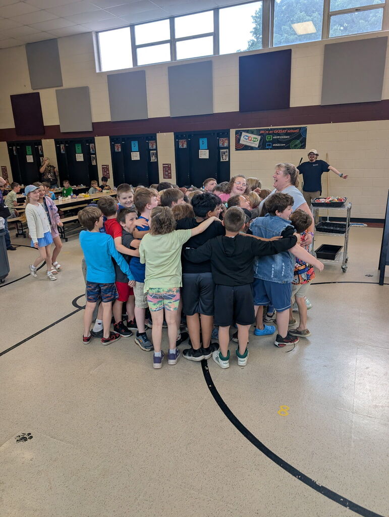 group of kids gathered around lunch lady 