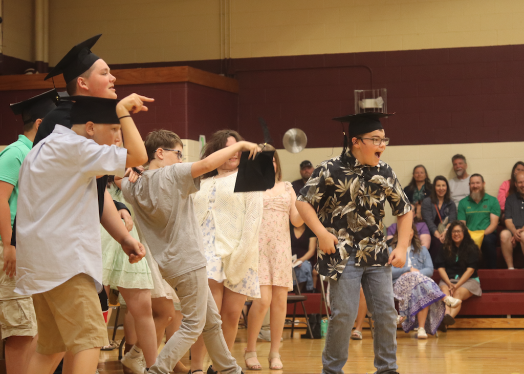 kids dancing up front of the assembly