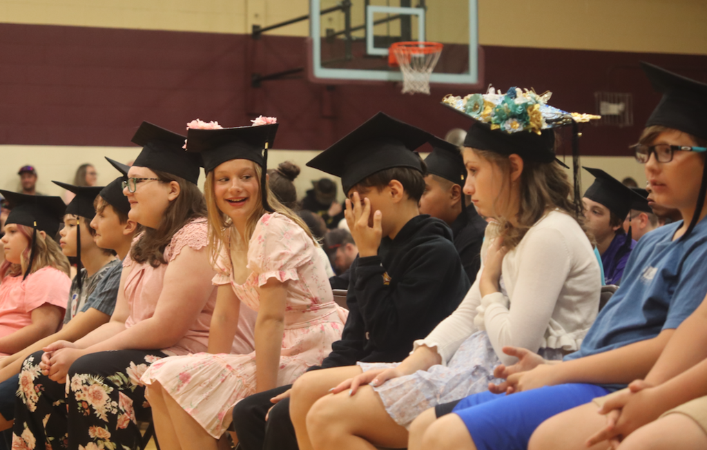 group of graduates sitting in the crowd