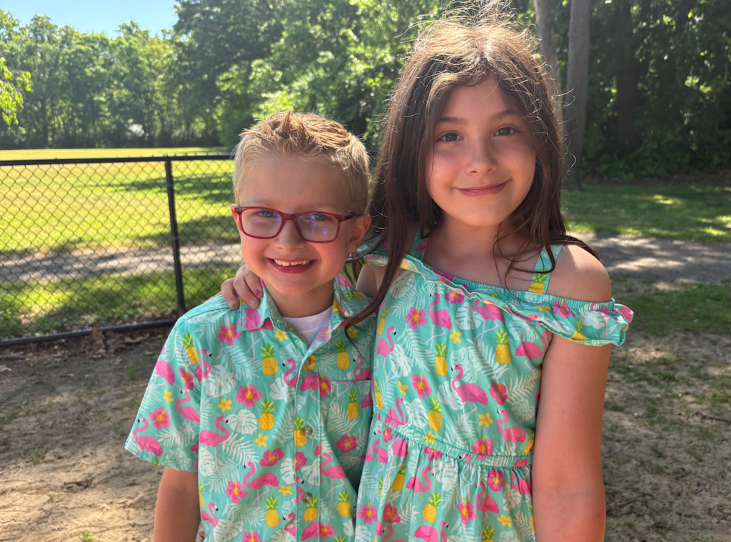 one girl and one boy dressed in matching flamingo outfits