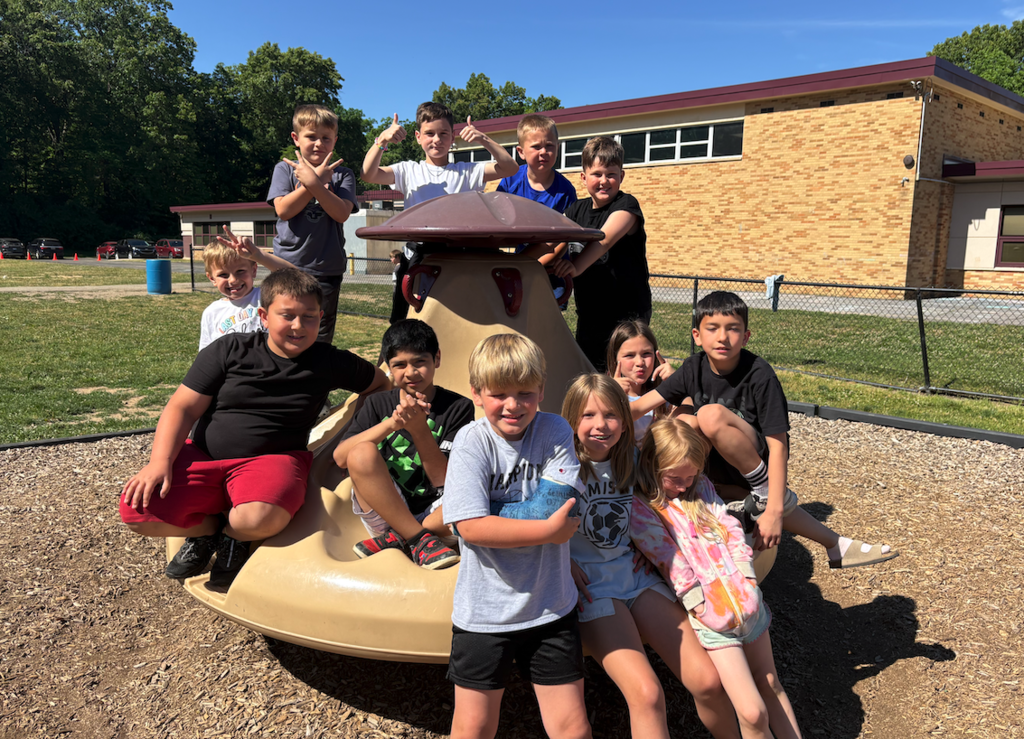 group of students on the merry go round