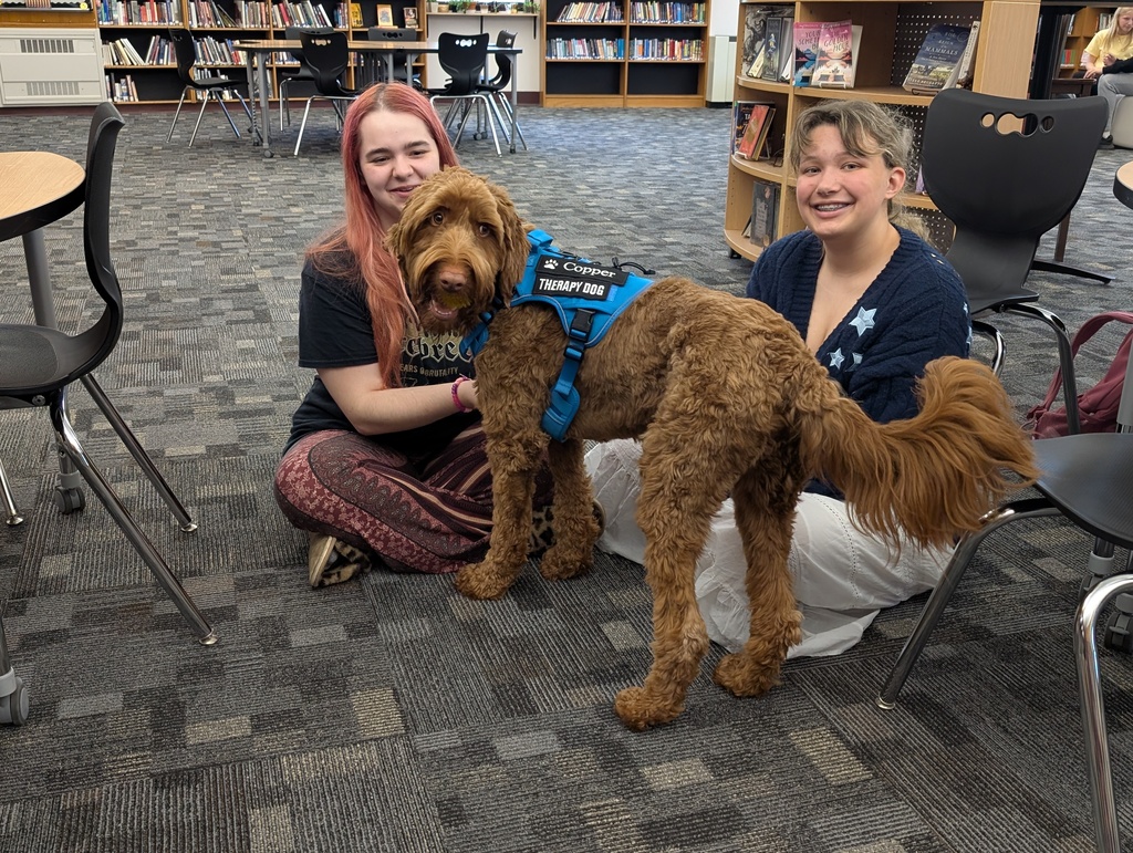 two female students with copper the dog