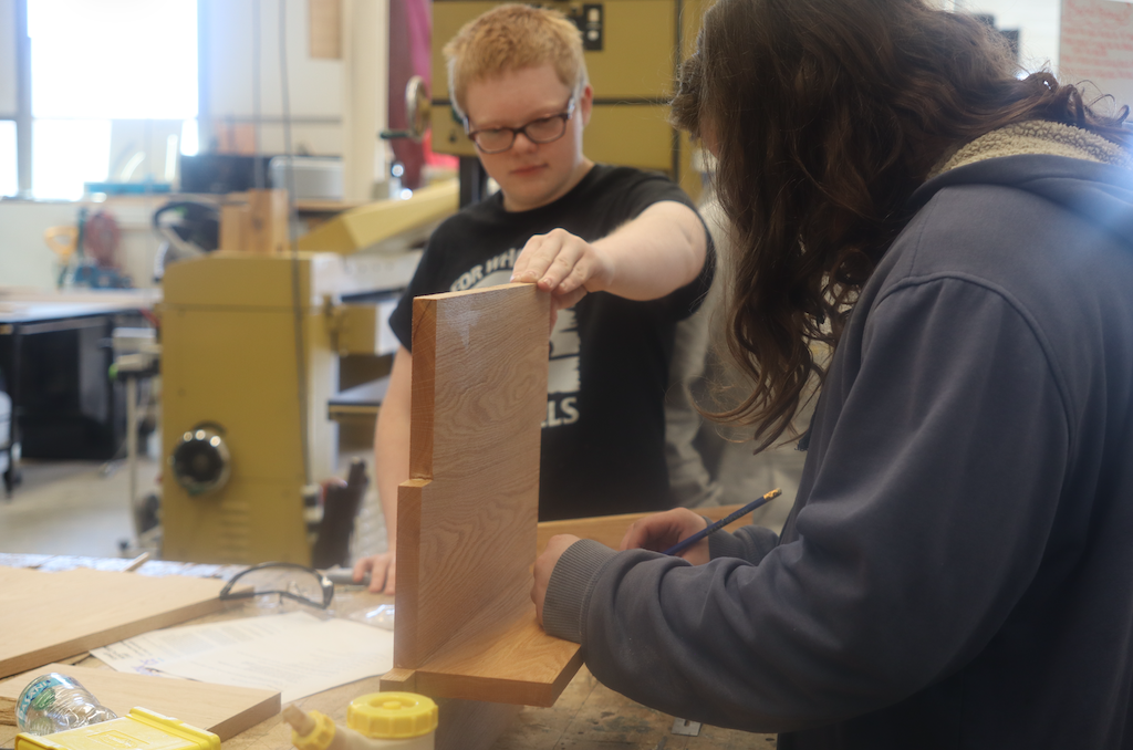 students working on wood pieces