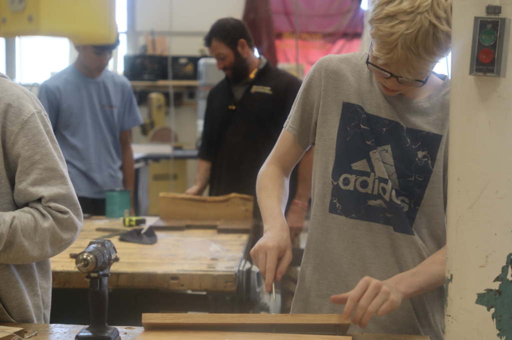 student working on wood piece