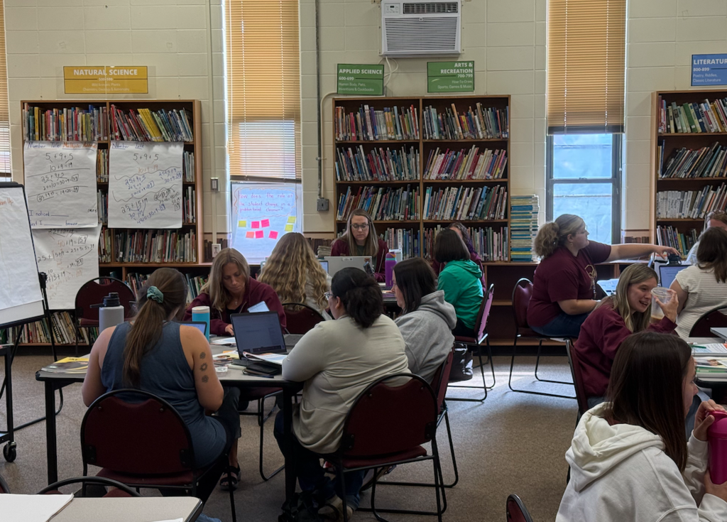 group of teachers in library learning math