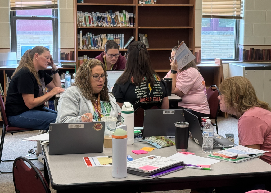 group of teachers in library learning math