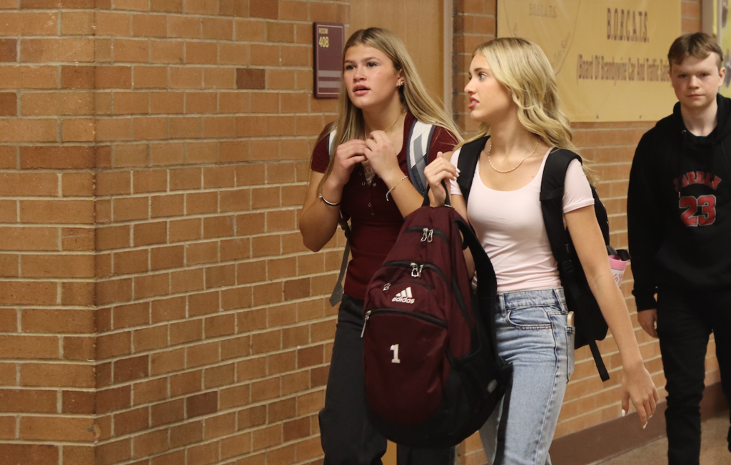 two girls walking in the hallway