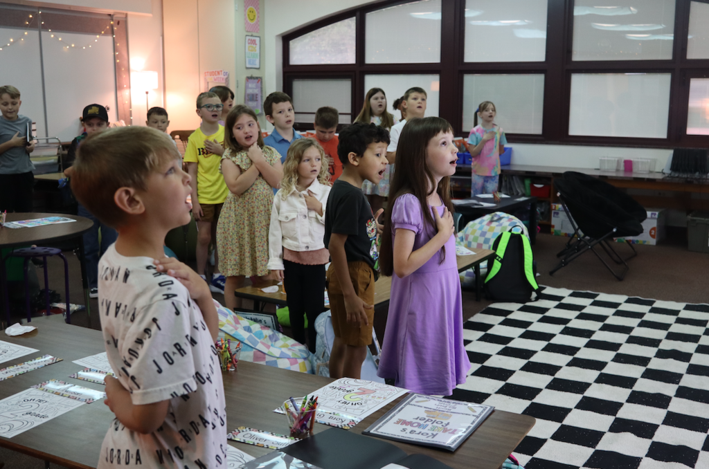 group of second graders reciting the pledge of allegiance