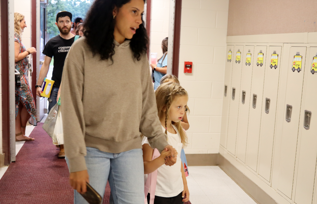 mom walking in with child