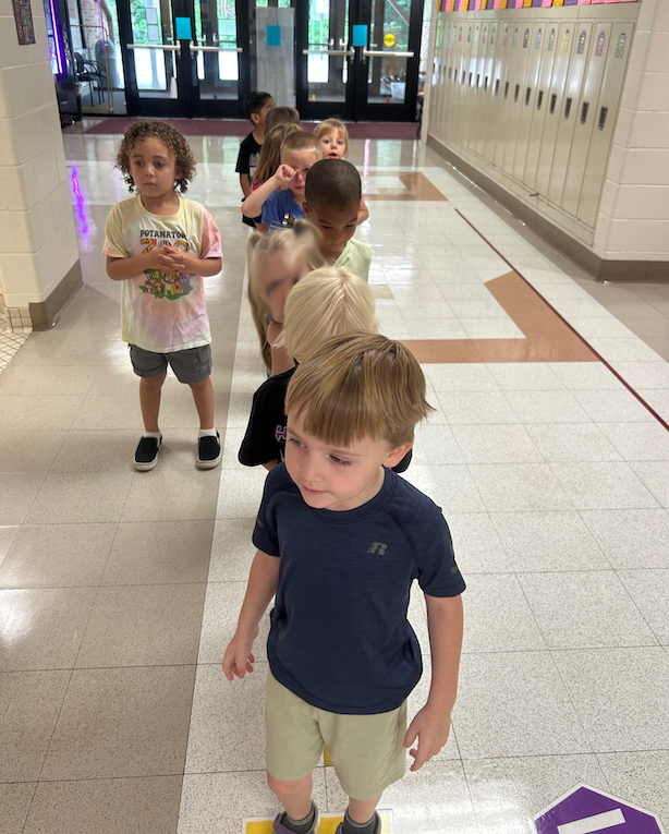 group of kids standing in single file line
