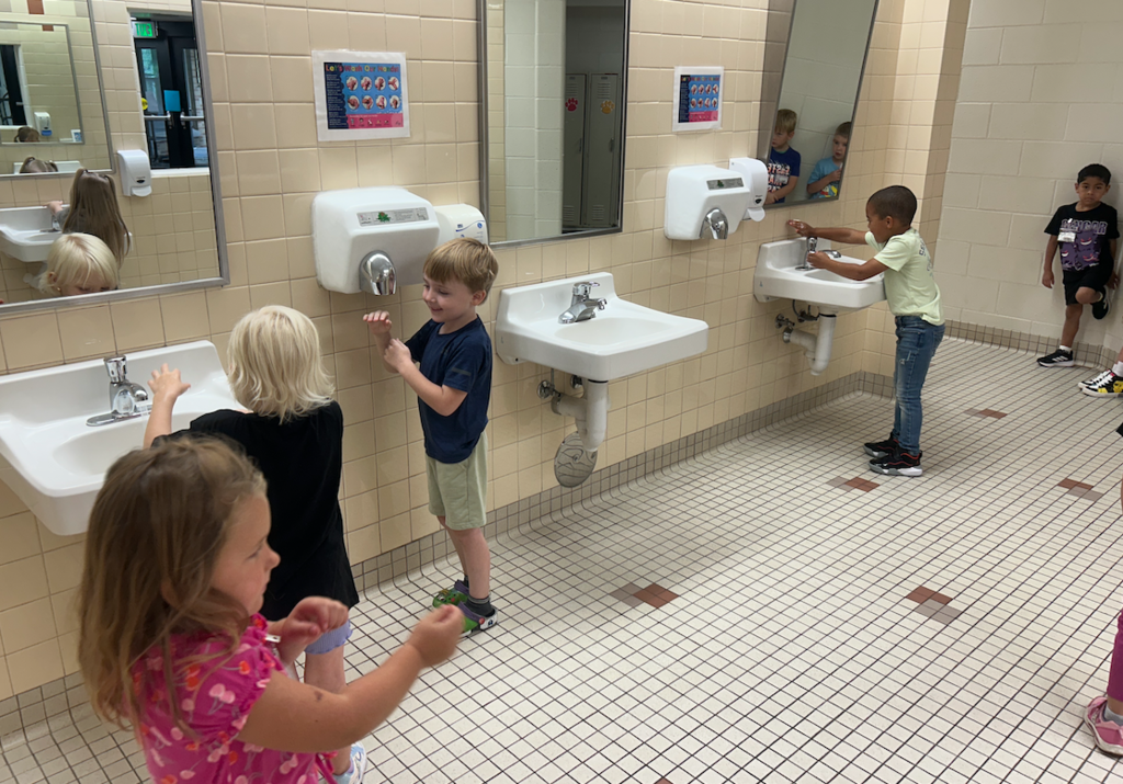 group of kids washing their hands