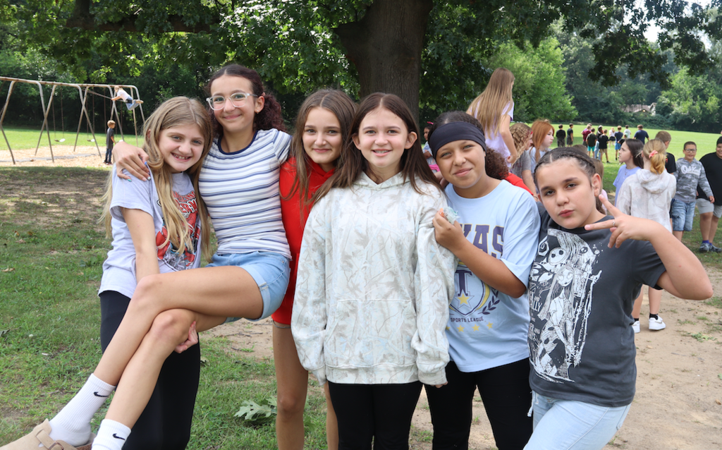 6 girls posing for picture on playground