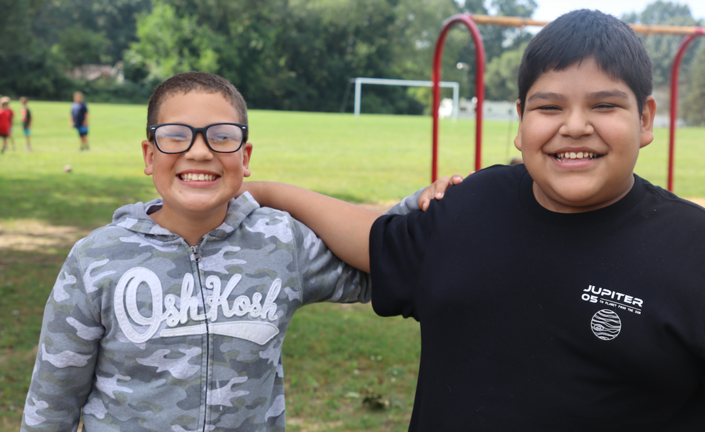 two boys smiling at the camera