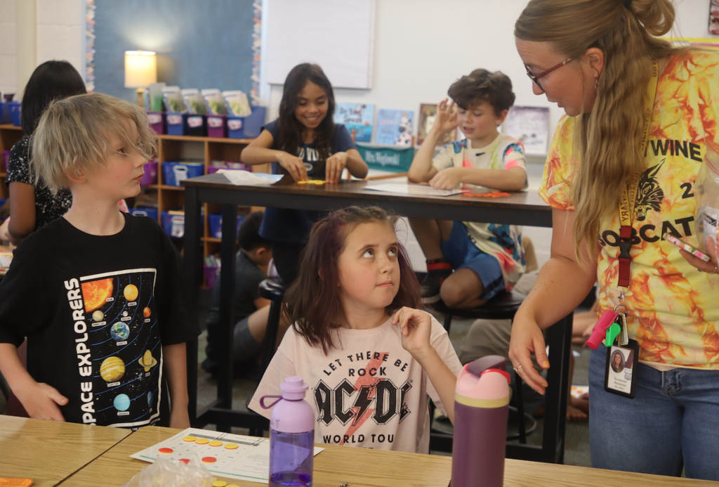 little girl talking to teacher