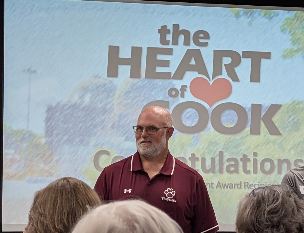 mr. pomranka in front of the heart of cook screen