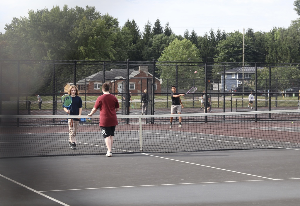 group of kids playing tennis