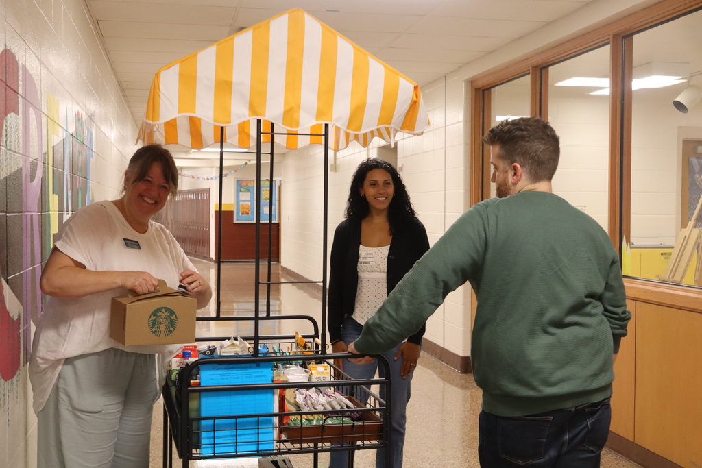 woman serving from a cart, woman and man talking to each other