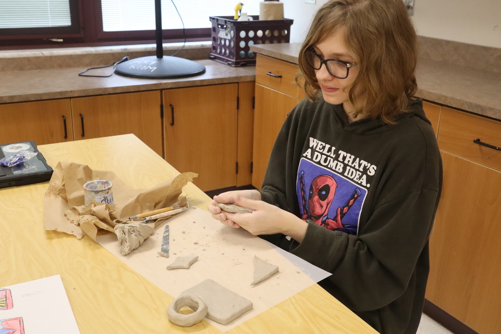 student doing art project