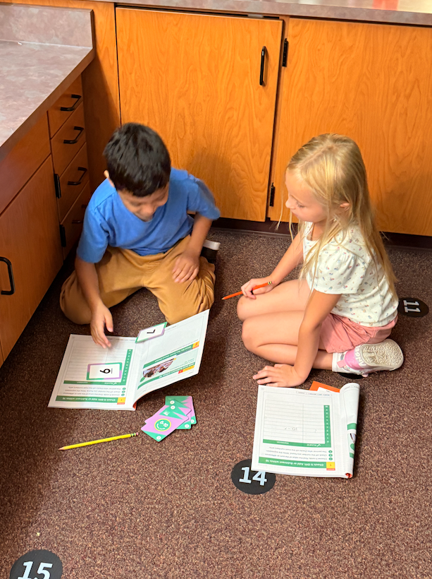 two kids sitting on the floor 