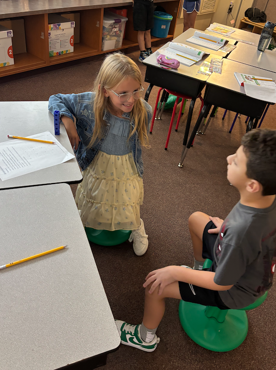 two kids sitting in classroom