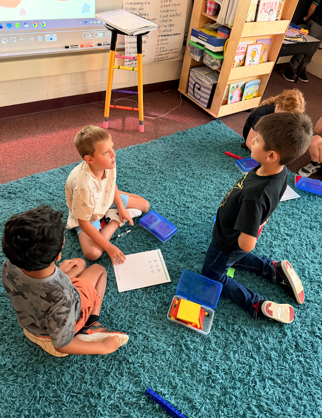 kids sitting on the floor playing a game