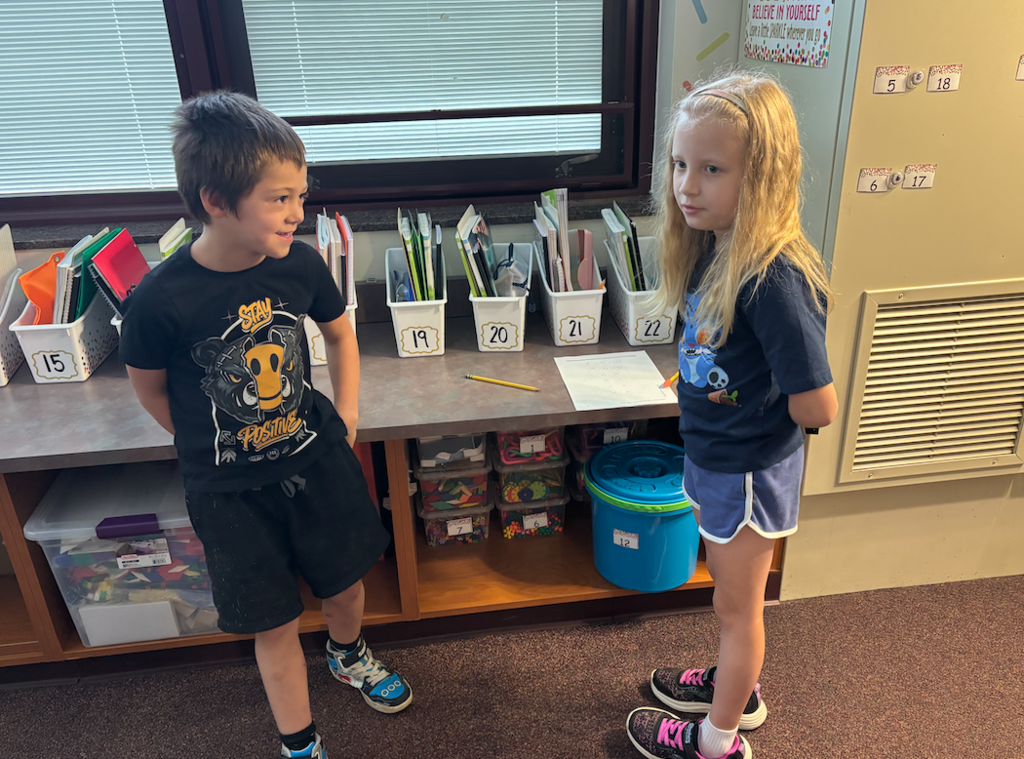 two kids playing game in classroom
