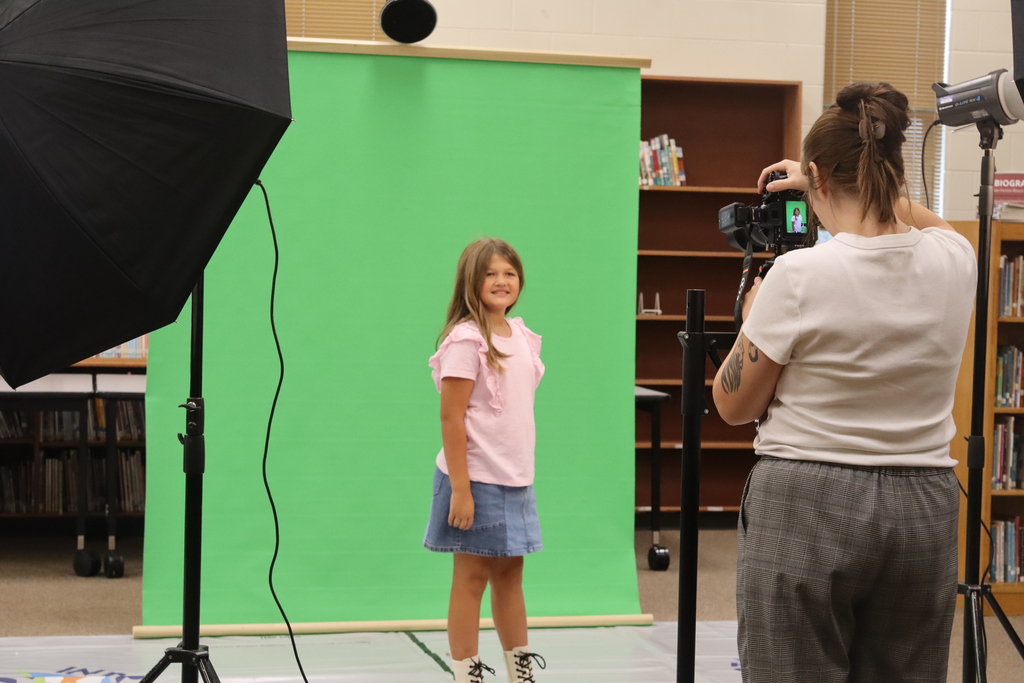 picture day little girl taking picture in front of camera