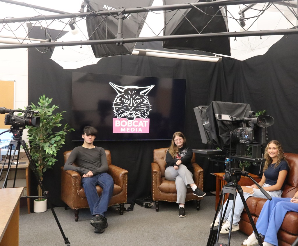 group of high schoolers sitting on chairs in podcast set