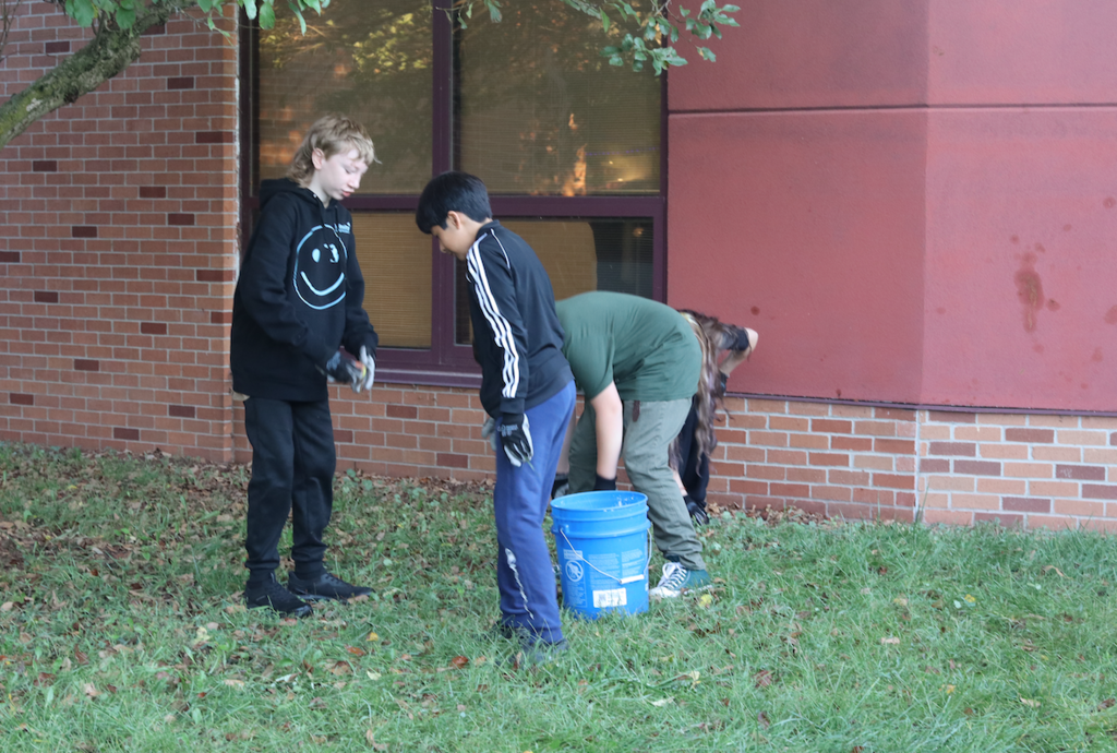 kids picking up apples in courtyard