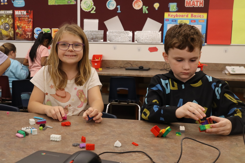 little girl and boy. building legos