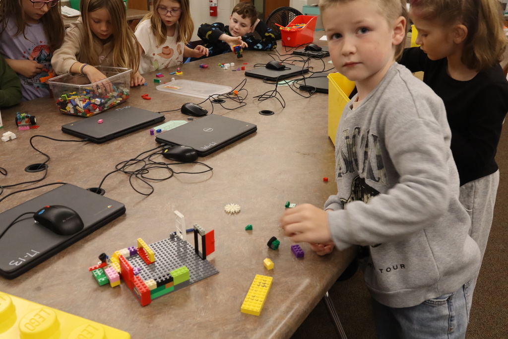 little boy showing off legos