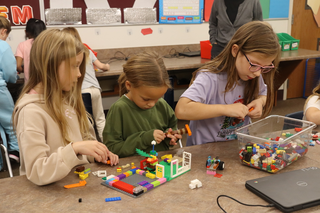 group of three girls working on legos