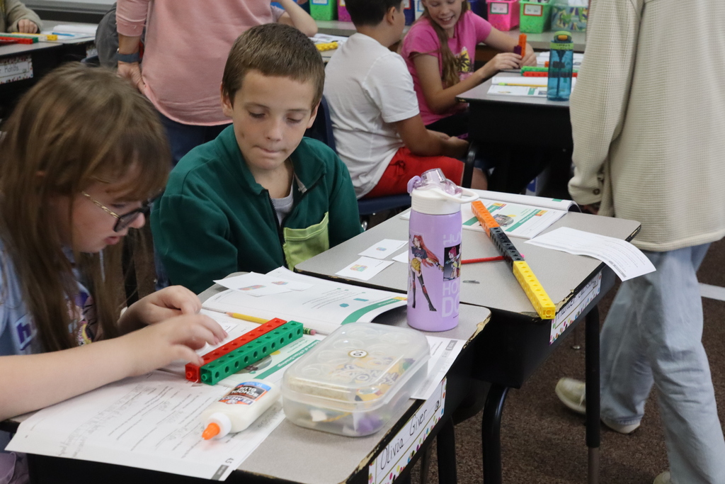 a boy and a girl working on cubes