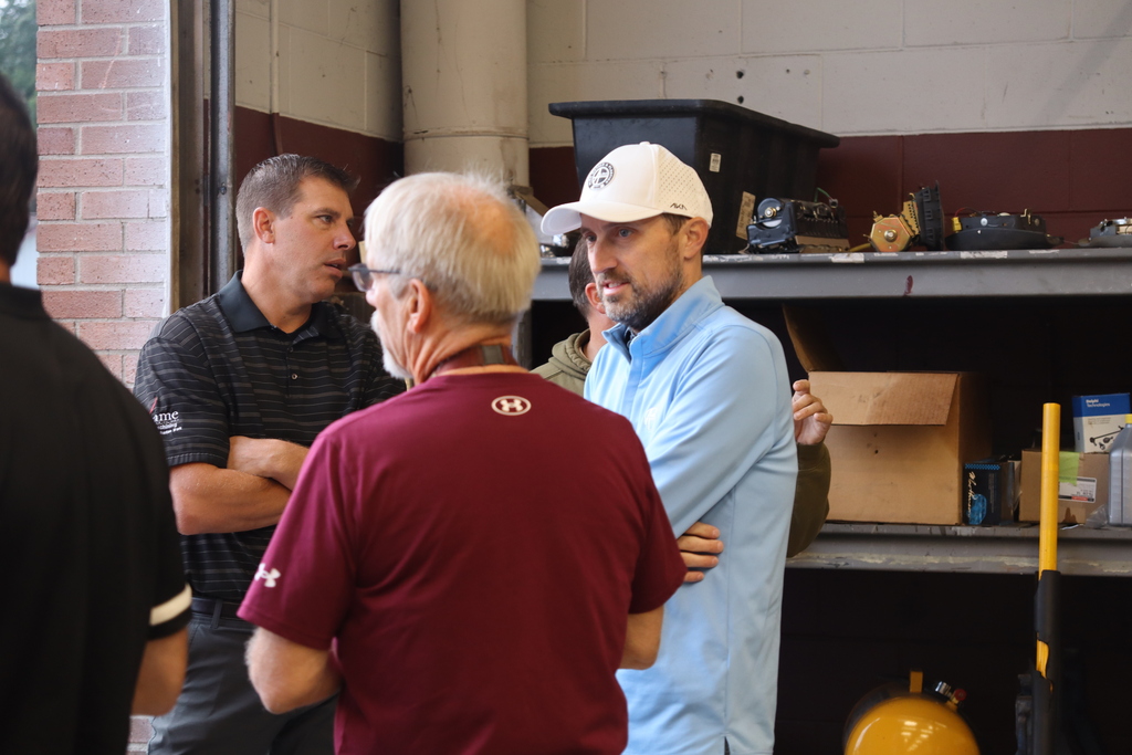 man talking to other man in auto shop