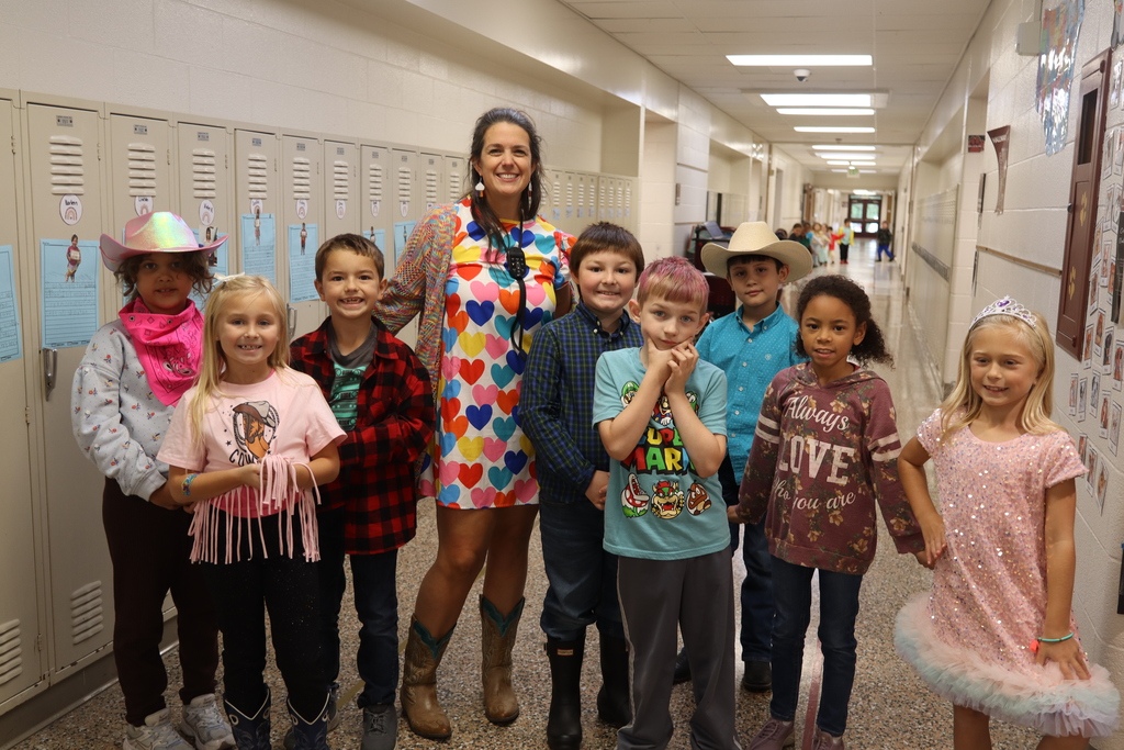 group of kids with teacher dressed up for dolly parton day