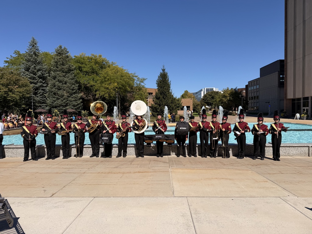 band standing in front of fountain with instruments