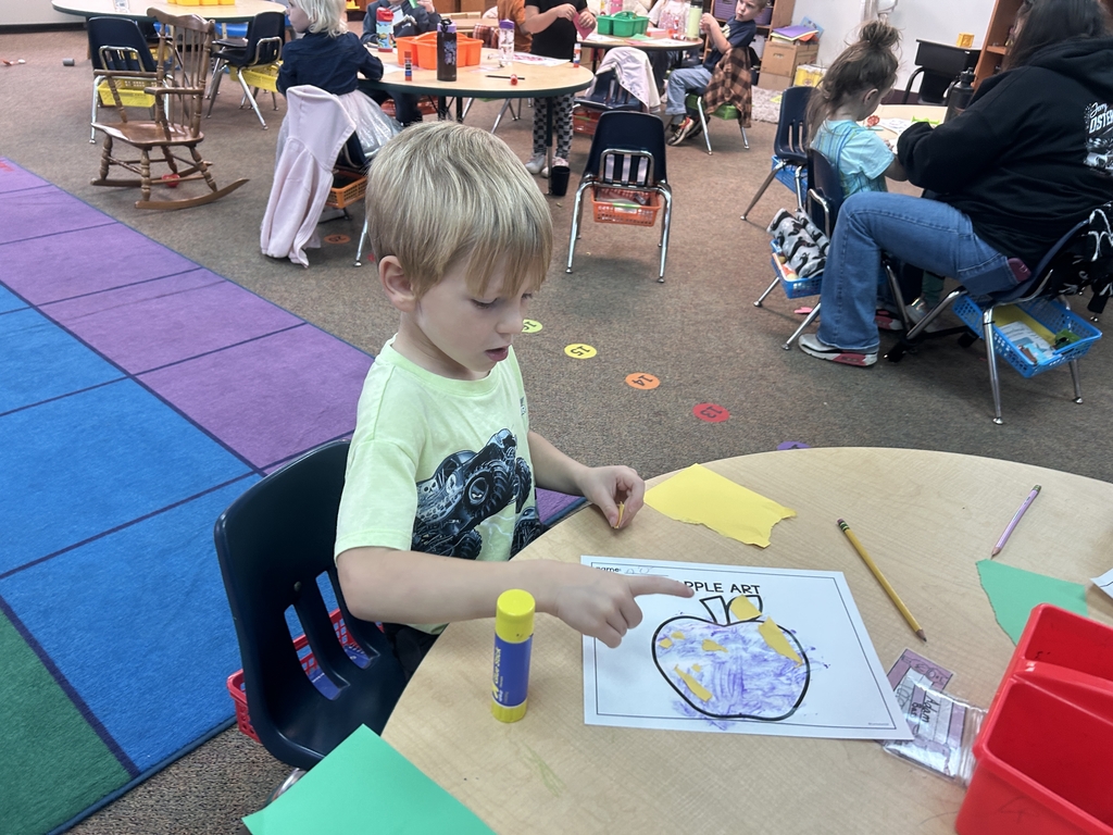 little boy coloring apple
