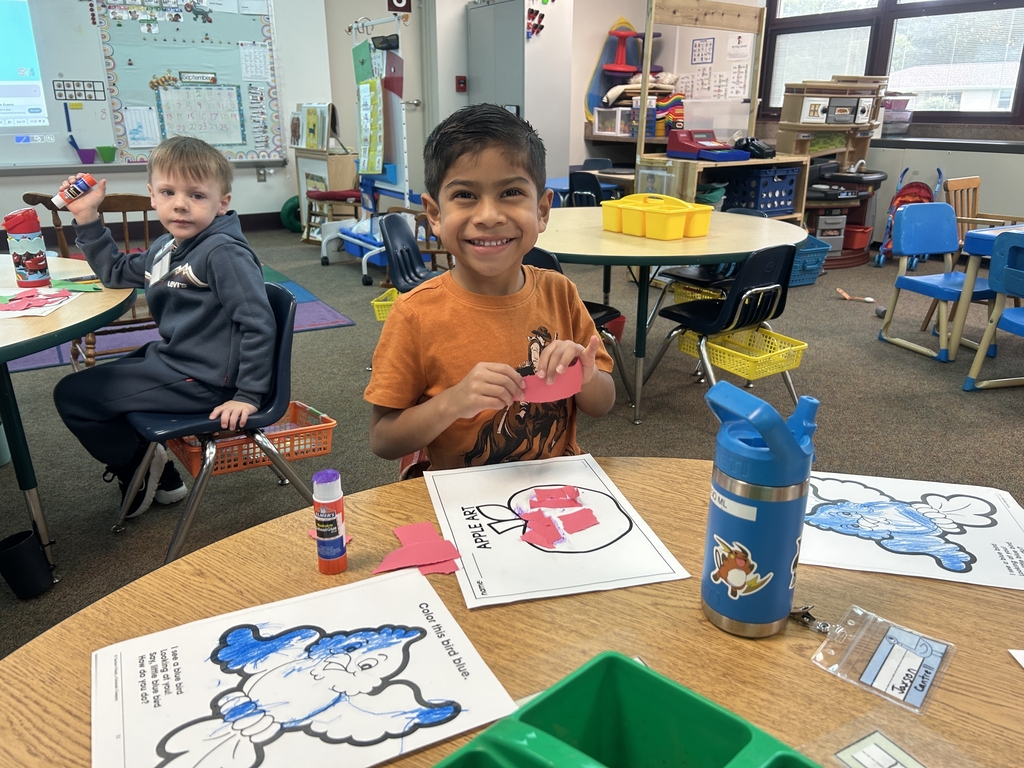 little boy coloring apple
