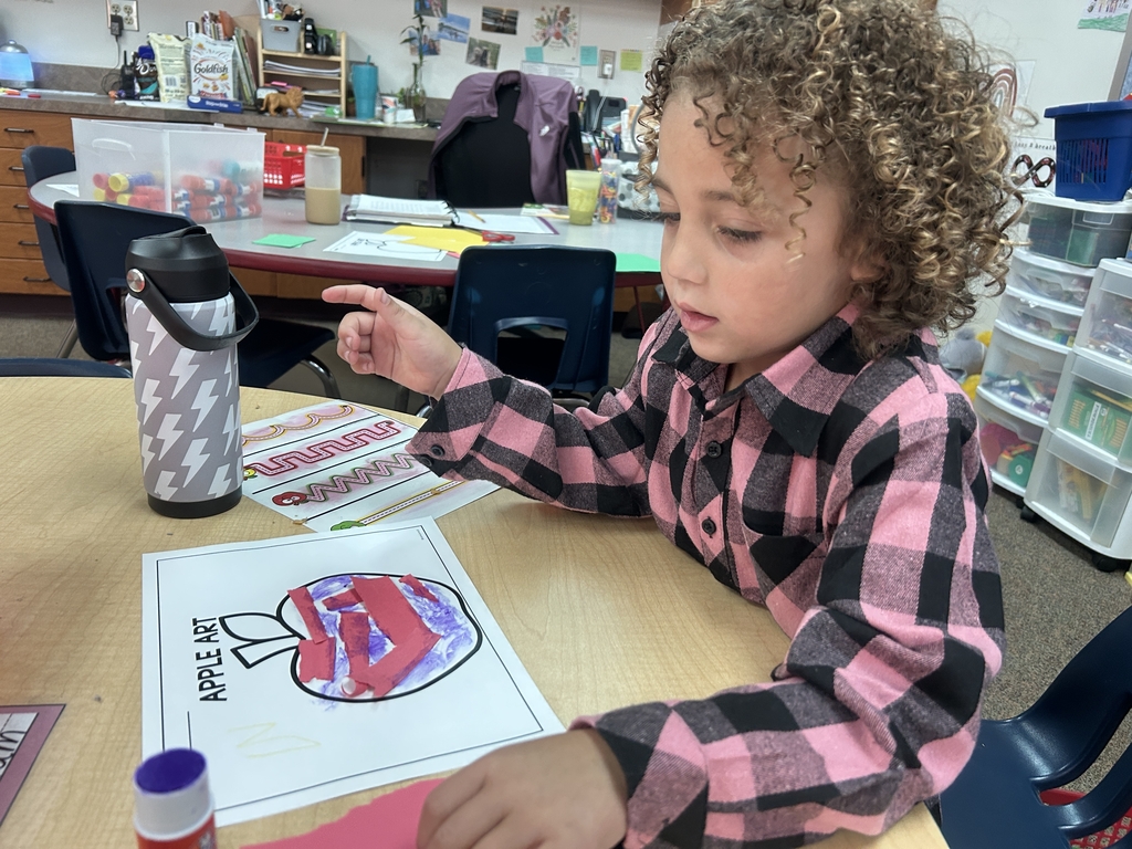 little girl coloring apple