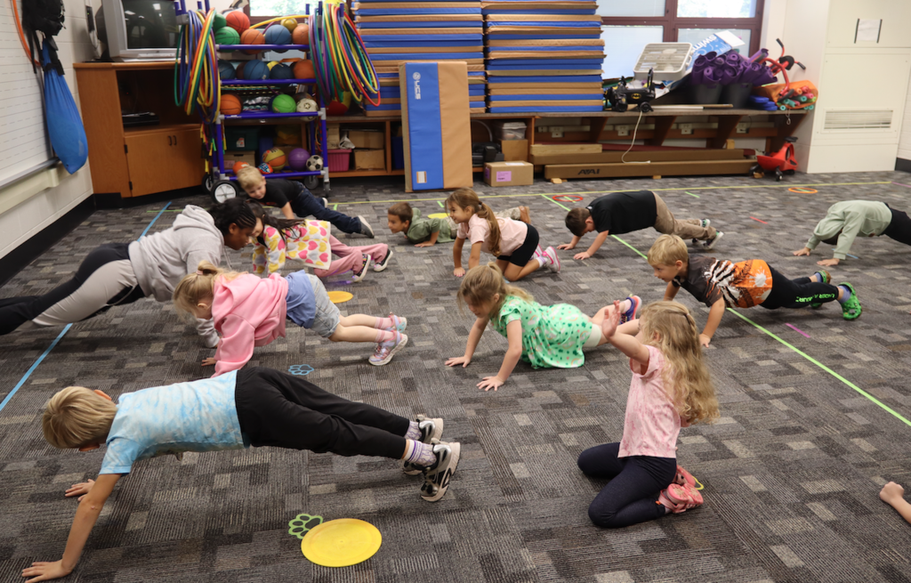 students doing push ups in classroom
