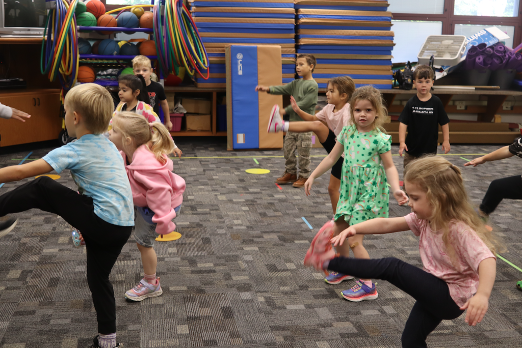class doing toe touches in classroom