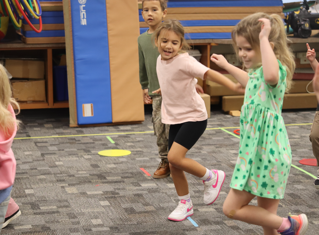 little girls jumping around in gym class