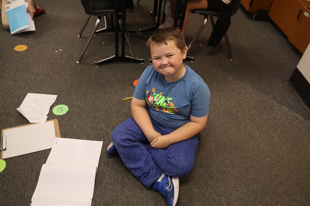 young boy sitting on the floor with the book
