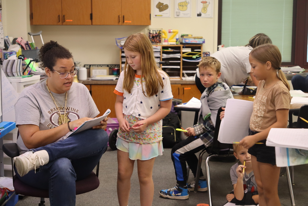 students getting feed back from teacher