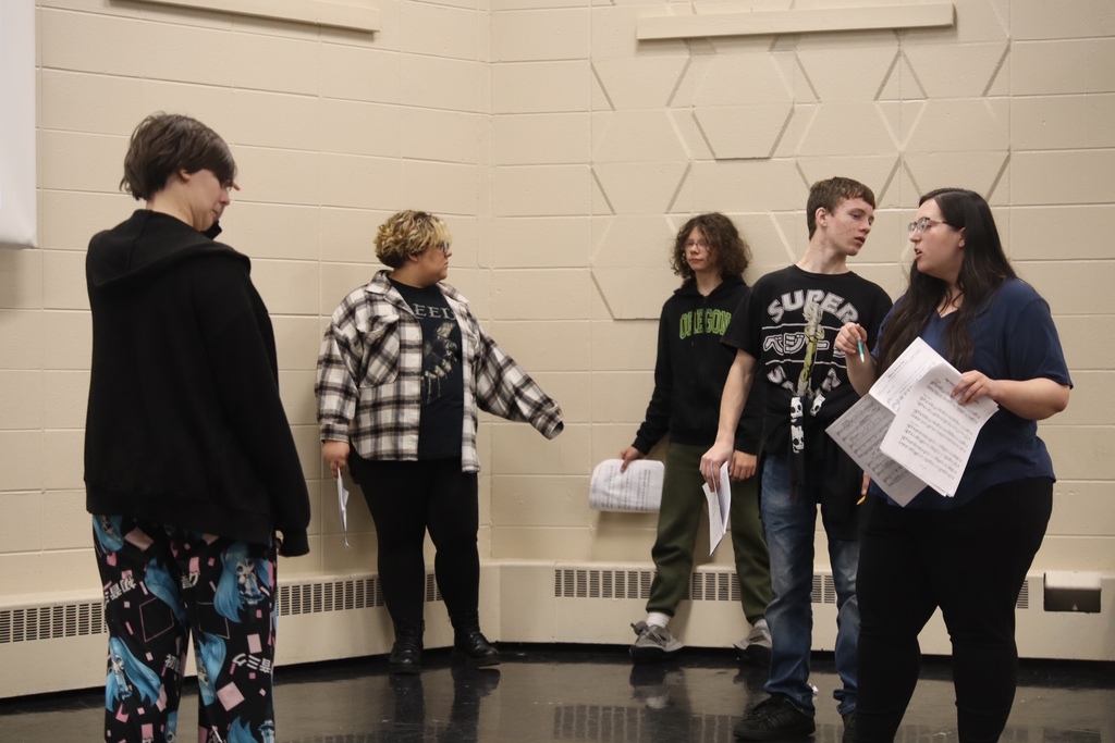 theatre teacher showing students around the stage