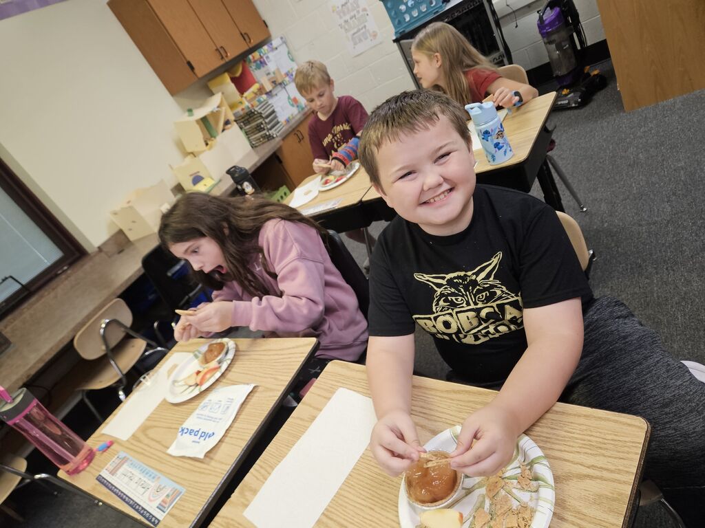 young boy and girl at desk with apple pie