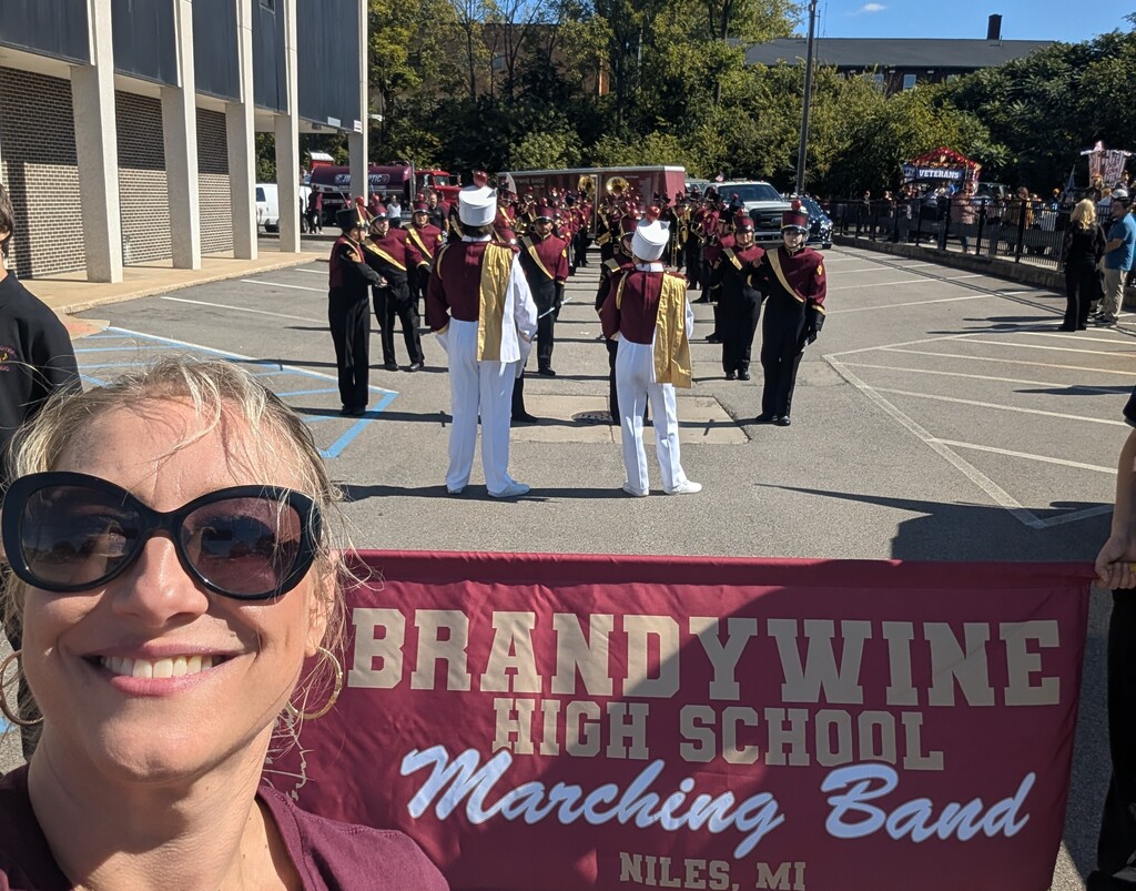 superintendent lezotte in front of band banner