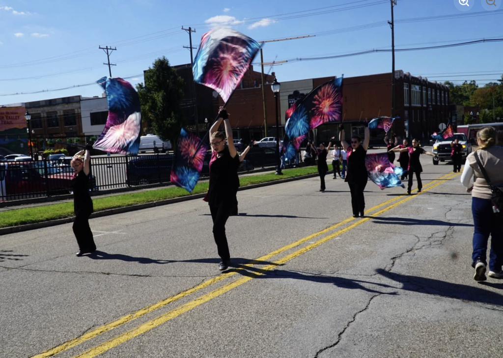 colorguard marching on street in parade